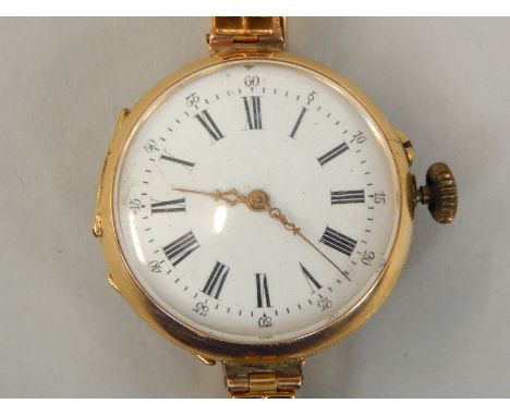 A 9ct gold ladies wristwatch, with white enamel circular dial, and florally engraved back, on expanding strap, 34.4g all in. 