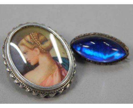 Two silver brooches, to include a butterfly wing brooch, and a portrait brooch. (2)