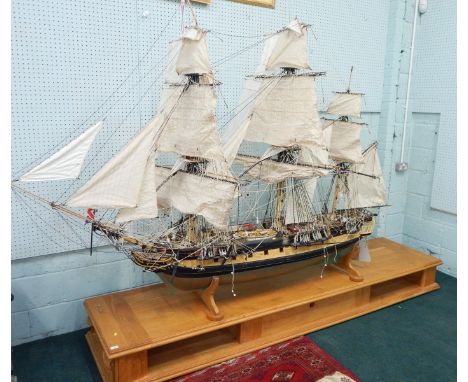 A large scale model of four masted ship, fully ridged and with figures, etc., with remote control, etc., on an adapted light 