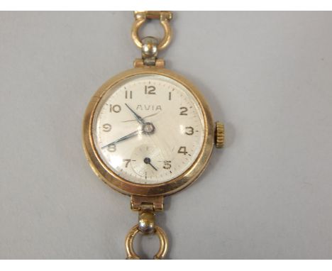 An Avia 9ct gold ladies wristwatch, on thin bracelet with white enamel dial and blue hands (AF), 18g all in.