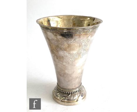 An early 20th Century Swedish silver vase with circular base below beaded border and flared body with part foliate engraved d