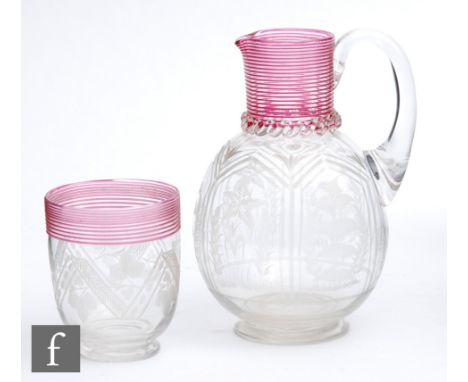 A late 19th Century Stourbridge glass water jug of footed ovoid form with collar neck decorated with fine ruby threading and 