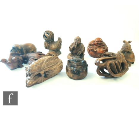 A collection of Japanese carved wooden netsuke, each modelled as a Buddha, pig, shrimp, cockerel, fish, immortal figure, tort