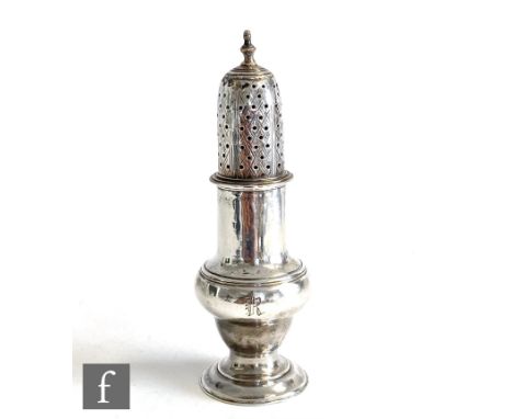 A George III hallmarked silver sugar castor of plain baluster form, plain body below pierced cover and stepped finial, height