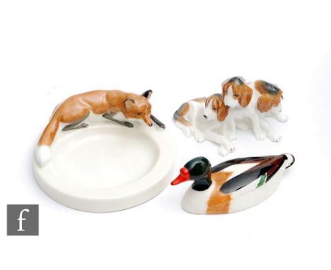 A Royal Worcester Fox pin dish modelled by Doris Lindner, model 2873, S/D, together with a Royal Worcester model of three pup