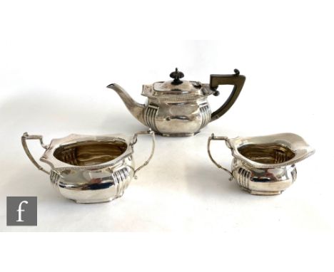 A hallmarked silver three piece boat shaped bachelor's tea set with part reeded decoration, total weight 19.5oz, Birmingham 1