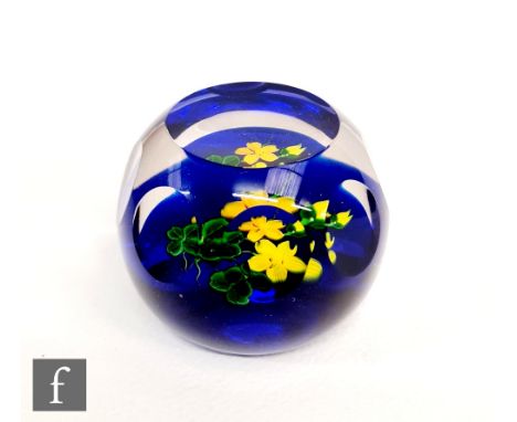 A later 20th Century Caithness paperweight, with a lamp worked yellow floral design contained in a printie panel cut dome, 36