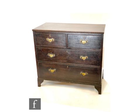 An early 20th Century oak chest of two short and two long drawers, brass fret drop handles, on bracket feet, height 86cm x de