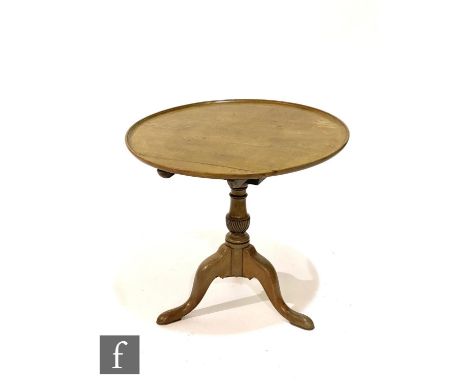 A George III mahogany occasional table with bird cage action to the pedestal, the top with a moulded edge over a wrythen-turn