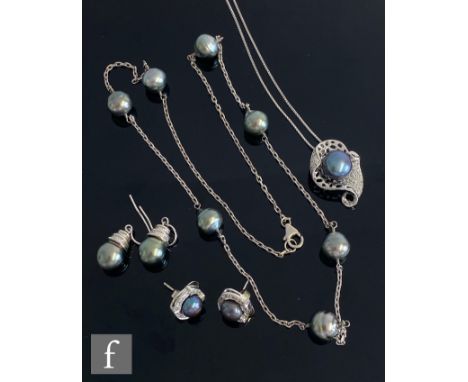 Two modern silver chains each set with Tahitian style grey pearls, each with a matching pair of earrings. 