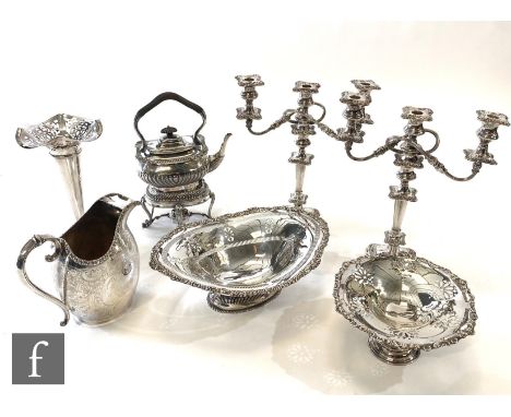 Assorted silver plated items to include a spirit kettle and stand, a water jug, a pair of three light candelabra, a swing bas