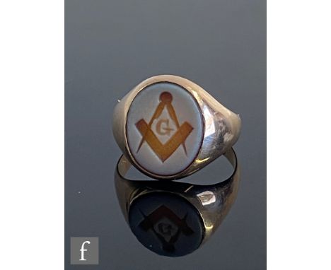 An early 20th Century 14ct Masonic signet ring, with compass and set square engraved to an oval hardstone set head, weight 4.