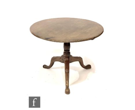 A George III mahogany and oak circular tripod occasional table on turned baluster pedestal, width 83cm. 