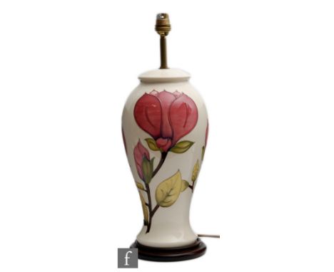 A large Moorcroft Pottery lamp base decorated in the Magnolia pattern with pink flowers against a white ground, marks obscure