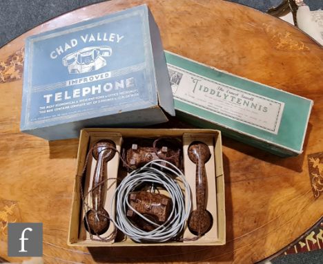 A Chad Valley Improved Telephone, with two walnut telephones in original box, and Ernest Sewell Tiddlytennis. (2) 