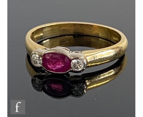 A modern 18ct hallmarked three stone ruby and diamond ring, central oval ruby flanked with diamond to each side, all stones c