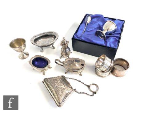 A parcel lot of assorted hallmarked silver items to include a three piece cruet, napkin rings, egg cups, a small purse, total