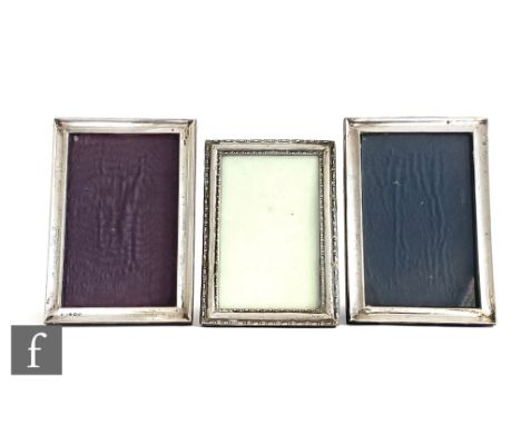 Three hallmarked silver rectangular easel photograph frames, two plain and one with beaded borders, tallest 16cm, various dat