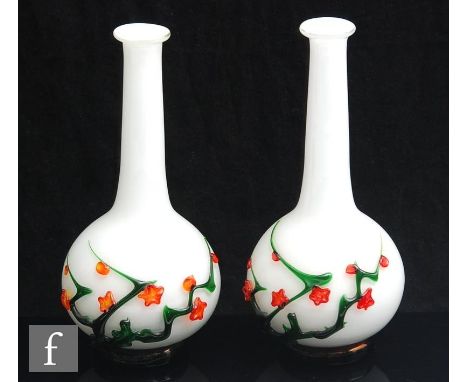 A pair of 20th Century Chinese Peking glass vases of footed globe and shaft form, decorated with flowering blossom boughs ove