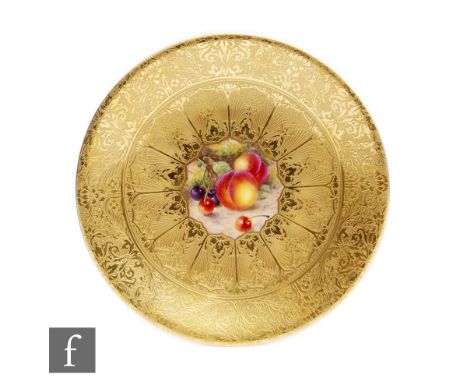 A Royal Worcester Fallen Fruits cabinet plate decorated by Freeman to a central cartouche with hand painted peaches and cherr