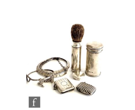 A hallmarked silver travelling shaving brush within two cylindrical silver sleeves, height 8cm, Birmingham 1923, with two sil