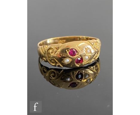 An early 20th Century 18ct ruby and seed pearl ring with gypsy set stones to a floral design, weight 2g, ring size M 1/2, sta