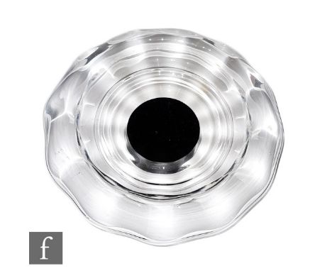 A 1930s Orrefors glass bowl in clear crystal with a roll rim and internal optic wave, mounted to a circular black foot, engra