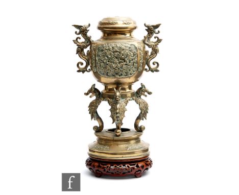 A Chinese late Qing Dynasty (1644-1912) censer, the lower circular plinth raised on four scroll dragon supports, surmounted b