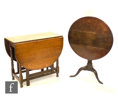 A 19th Century circular oak tripod occasional table on splayed legs, diameter 74cm and a 1930s drop flap gate leg dining tabl
