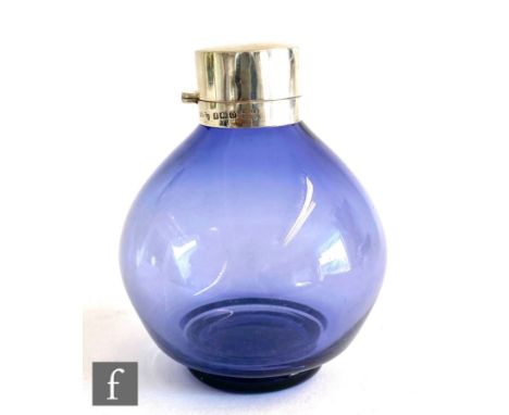 A hallmarked silver and glass globular scent bottle, the purple glass body below plain silver collar and hinged cover, height