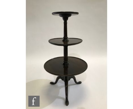 A mahogany graduated three-tier dumb waiter with turned pedestals and a tripod base, height 97cm and diameter of largest tier