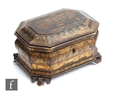 An early 20th Century Chinese black lacquered tea caddy of&nbsp;sarcophagus form, on carved dragon supports, detailed in gilt