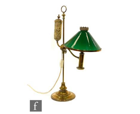 An early 20th Century brass library reading lamp, with green conical glass shade and adjustable height bracket, height of sta