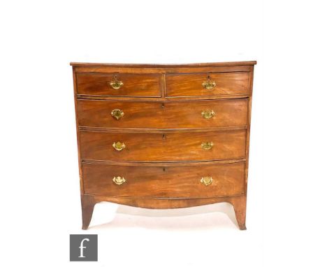 A George III mahogany bow front chest of two short and three long drawers, later brass fret drop handles, on splayed bracket 