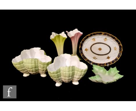 A 19th Century oval spoon tray decorated with gilt insects and floral sprays with a blue and gilt pattern edge, painted cresc
