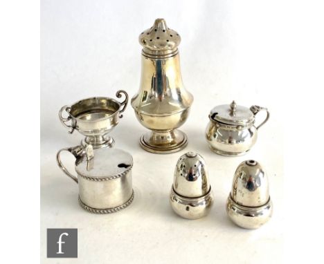 Six hallmarked silver items to include two mustard pots, a salt and a pepper, each modelled as an acorn, sugar castor etc, to