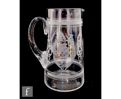 A late Victorian clear glass jug of cylindrical form, decorated with alternating engraved and etched repeat pattern of foliat