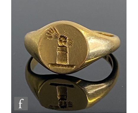 An 18ct hallmarked signet ring with intaglio engraved with a crest of a fist clenching a wheat sheaf to a circular head, weig