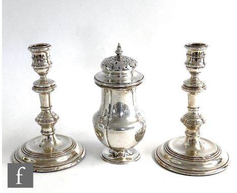 A pair of hallmarked silver candlesticks, circular stepped bases below knopped columns and circular sconces, height 17cm, Lon