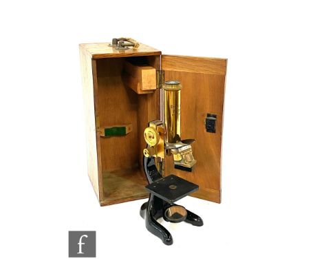 An Ernst Leitz brass microscope No 233143 in fitted oak case. 
