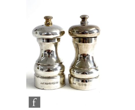 A hallmarked silver pepper and salt mill, each of plain baluster form, pepper with gilt finial, heights 11cm, Birmingham 2008