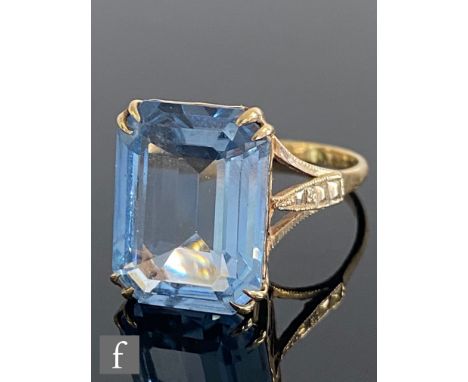 A 9ct hallmarked single stone blue topaz ring, emerald cut claw set stone, length 16mm, weight 5.4g, ring size R. 