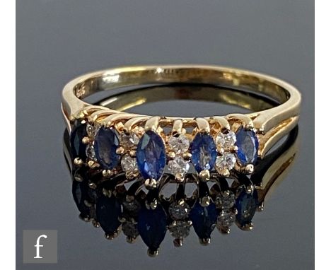 A 14ct sapphire and diamond ring, five marquise sapphires each spaced by a pair of diamonds, all stones claw set to split sho