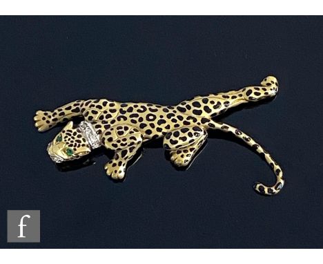 A modern 14ct brooch modelled as a crawling leopard with black enamel spots, emerald set eyes and diamond collar and snout, w