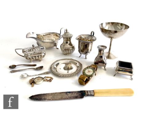 A parcel lot of assorted hallmarked silver items to include a goblet, condiments, a sauce boat, a cream jug etc, total weight