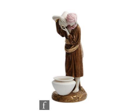 A late 19th Century Royal Worcester model of an Eastern water carrier, modelled by James Hadley, standing barefoot on a rocky