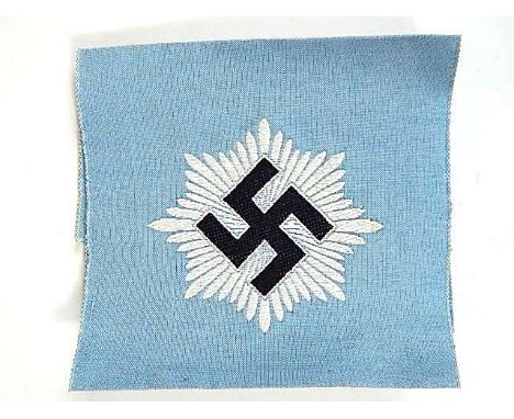 GERMAN RLB OFFICER'S 2ND MODEL ARMBAND BY H & F  bearing an embroidered swastika device and 'ges. gesch. H & F' on light blue