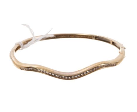 Gold (9ct) diamond hinged bangle with a waved band of channel set diamonds CONDITION REPORT Total gross weight 11.7 grams