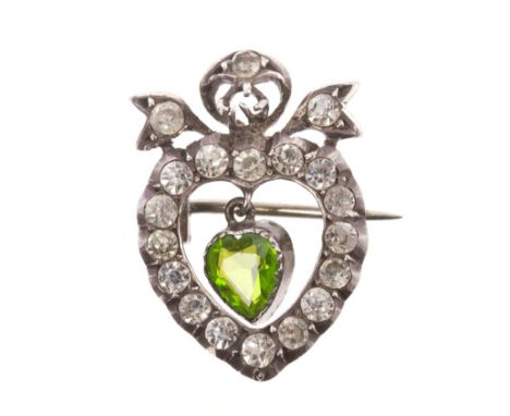 Antique paste set heart-shape brooch with a central green paste stone suspended within heart-shape surround with ribbon surmo