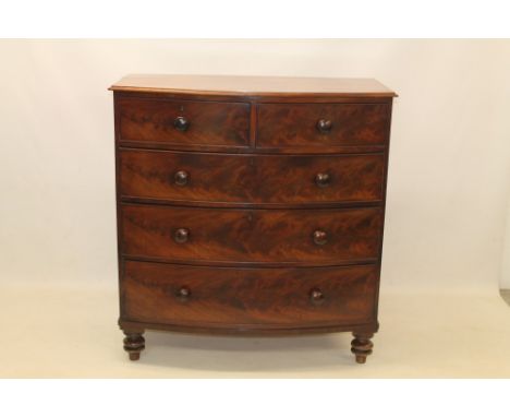 George IV mahogany bow front chest of drawers with moulded top and two short over three long graduated drawers, on turned fee